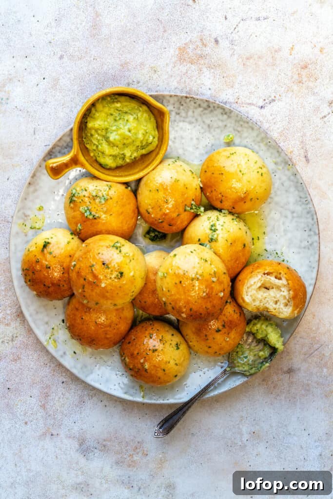 Plate with garlic dough balls and dip on the side