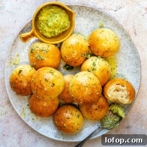 Plate with garlic dough balls and dip on the side