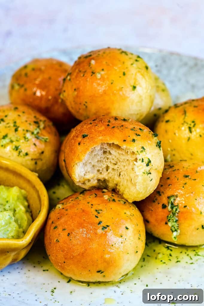 close up on garlic dough balls, one with bite taken out