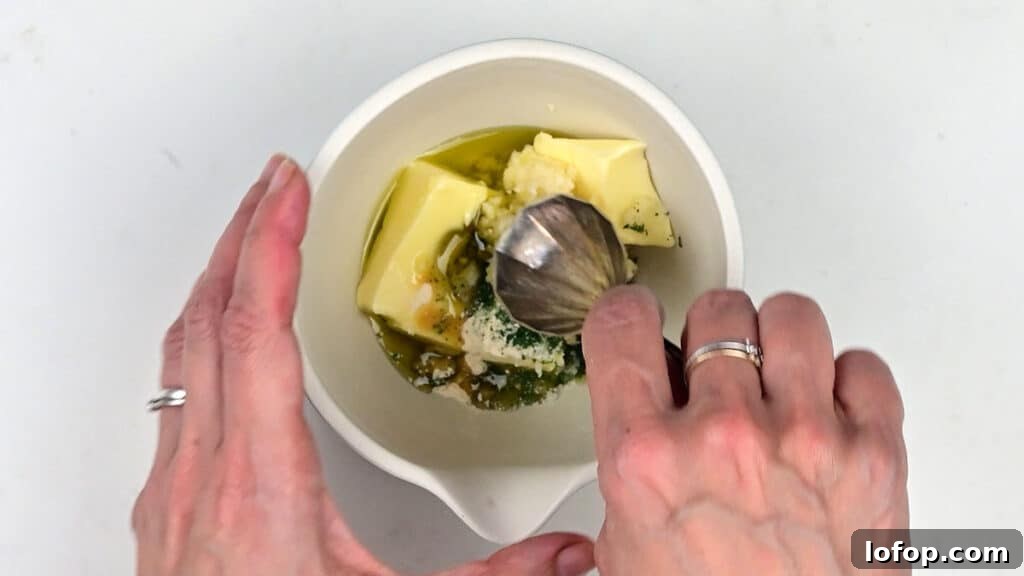 preparing garlic butter in a small bowl