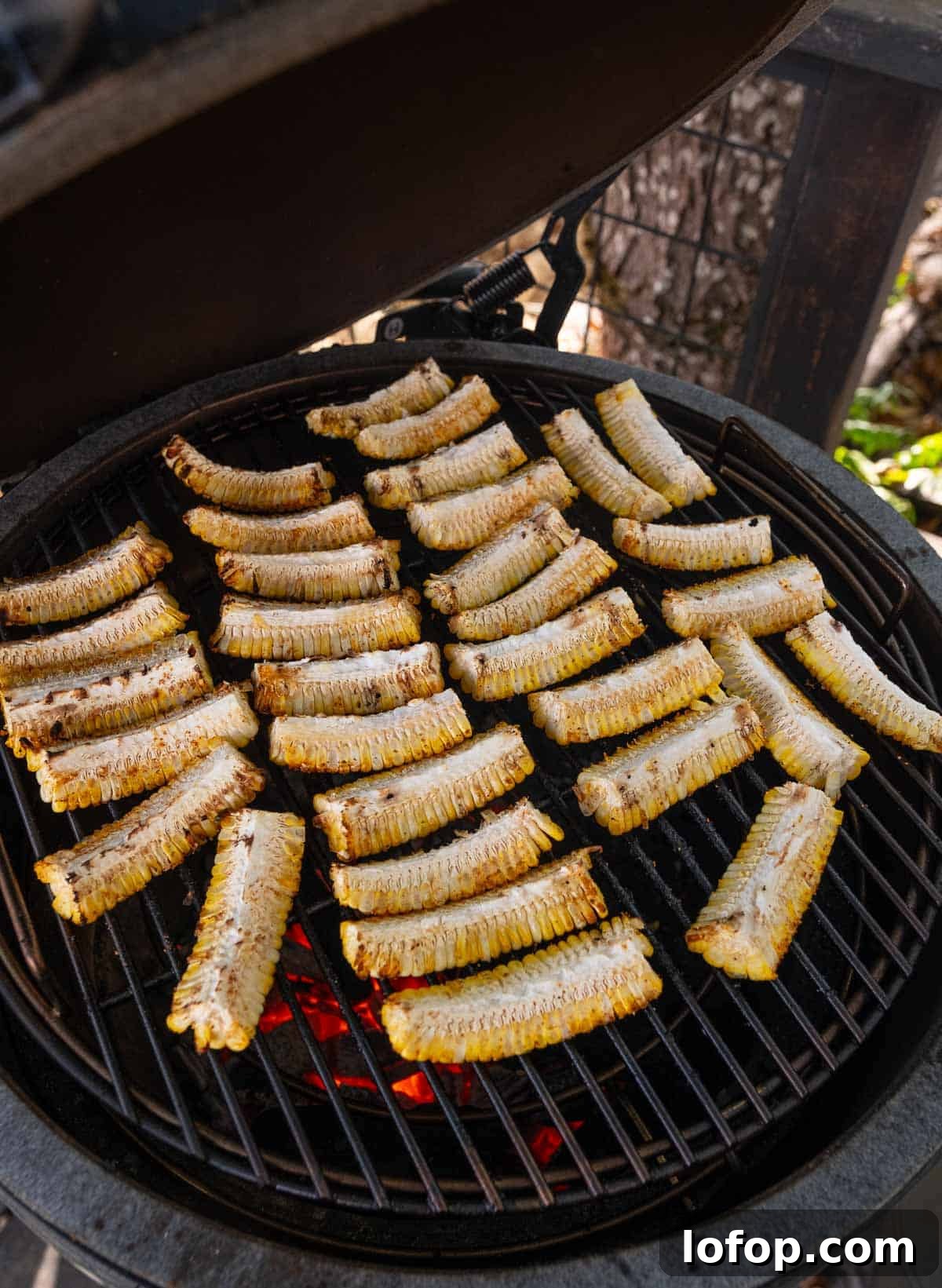 Grilling corn ribs on a charcoal grill.