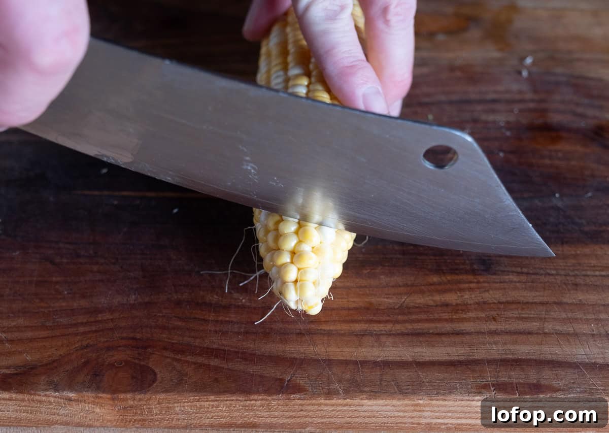 Slicing the tip off of a corn cob.