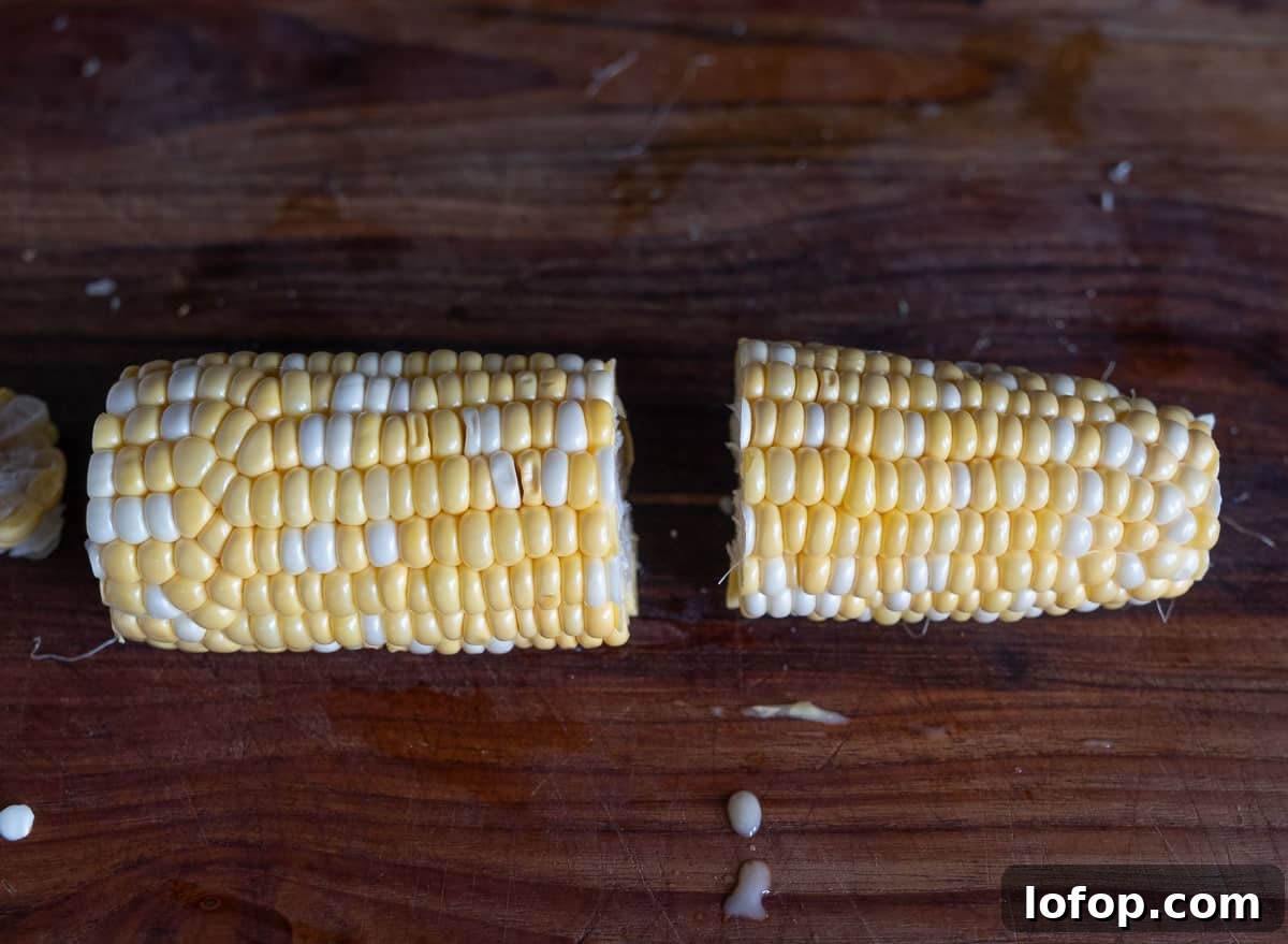 A trimmed corn cob cut in half lengthwise.