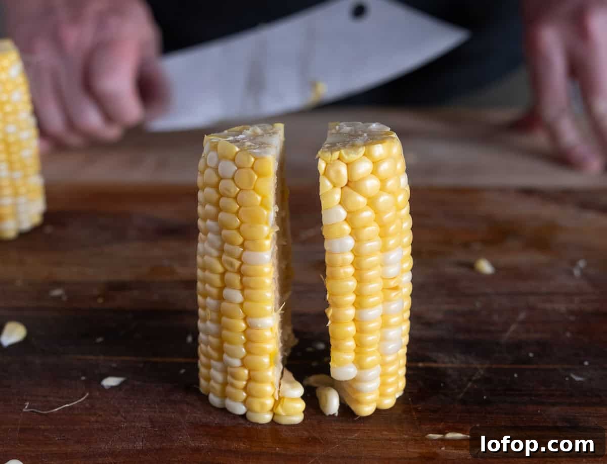 Cutting the halves of the corn halves again.
