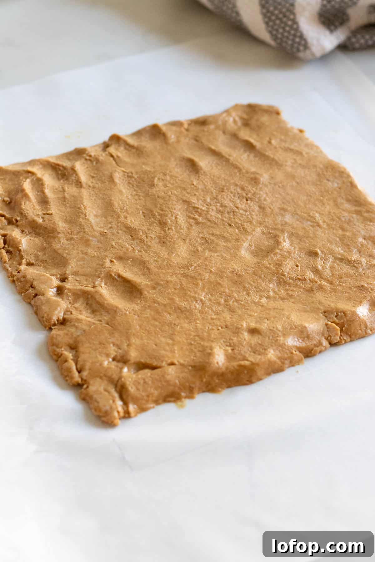 Decadent Peanut Butter Cup Fudgy Brownies Recipe 5 peanut butter filling rolled out into a square sitting on parchment