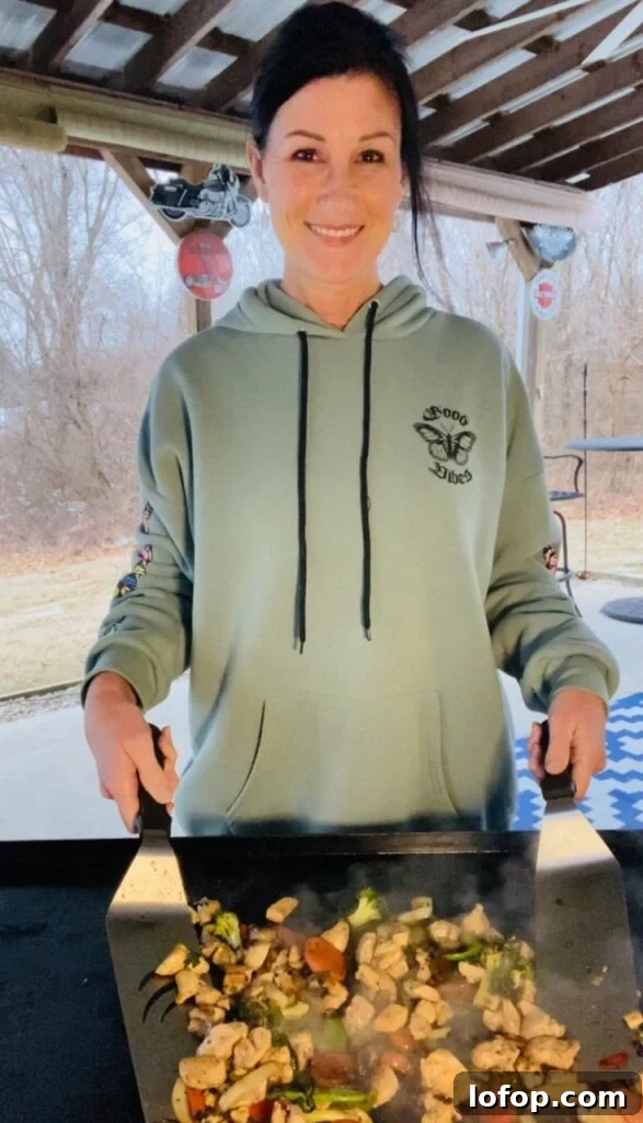 mixing Blackstone Peanut Chicken Stir Fry