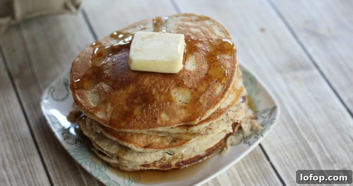 stack of low carb pancakes with a pat of butter and sugar free syrup