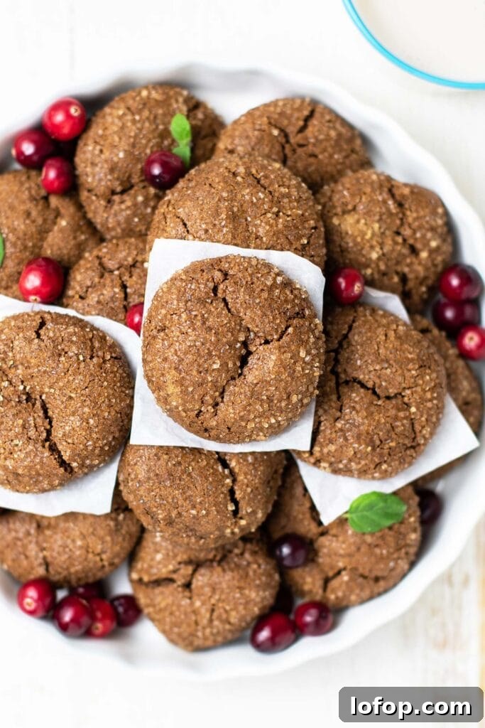 A dish filled with chewy ginger sugar cookies.