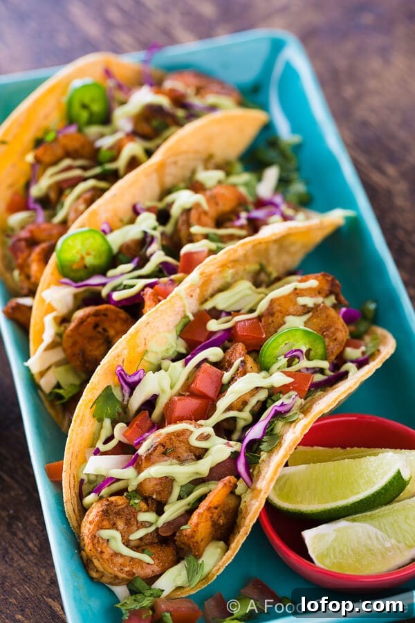 Baja Shrimp Tacos Recipe — Grilled or Stovetop Method 5 Spicy grilled shrimp tacos on a plate.
