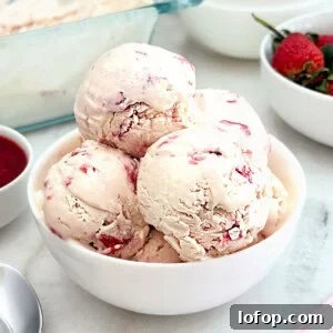bowl of homemade strawberry ice cream with fresh strawberries.
