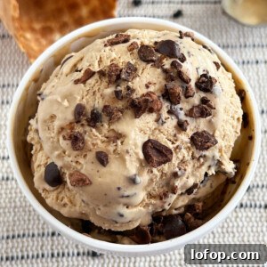 bowl of no-churn coffee ice cream with chocolate covered espresso beans on top.