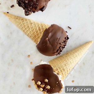 homemade drumsticks ice cream cones with chocolate coating on marble surface