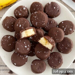frozen chocolate banana bites with flaked sea salt on a plate