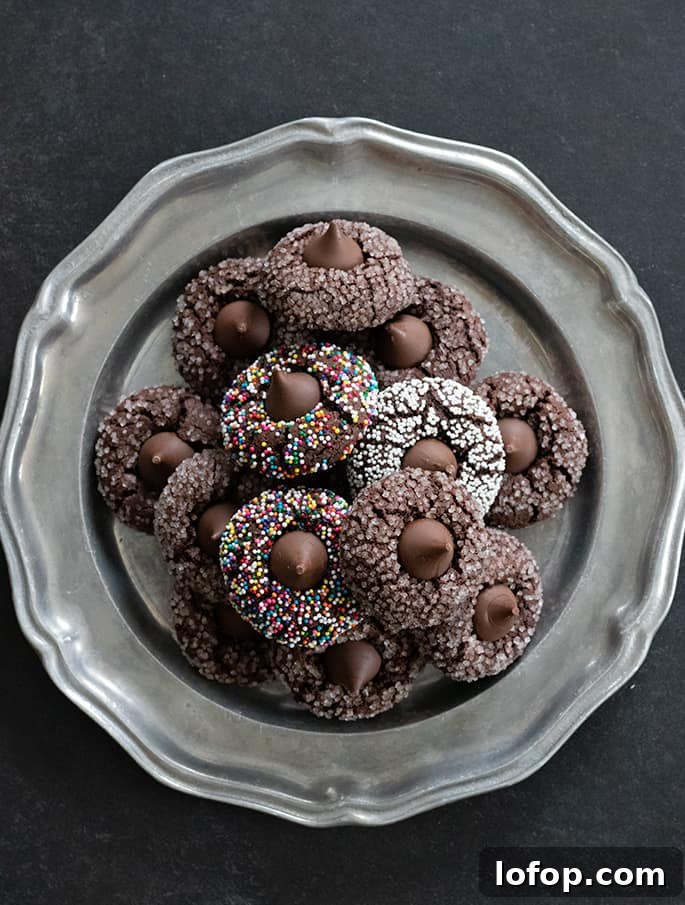 Gluten-Free Chocolate Kiss Cookies with Optional Peanut Butter 5 Overhead image of platter of gluten free chocolate kiss cookies, some with nonpareils and others with coarse sugar on the outside.