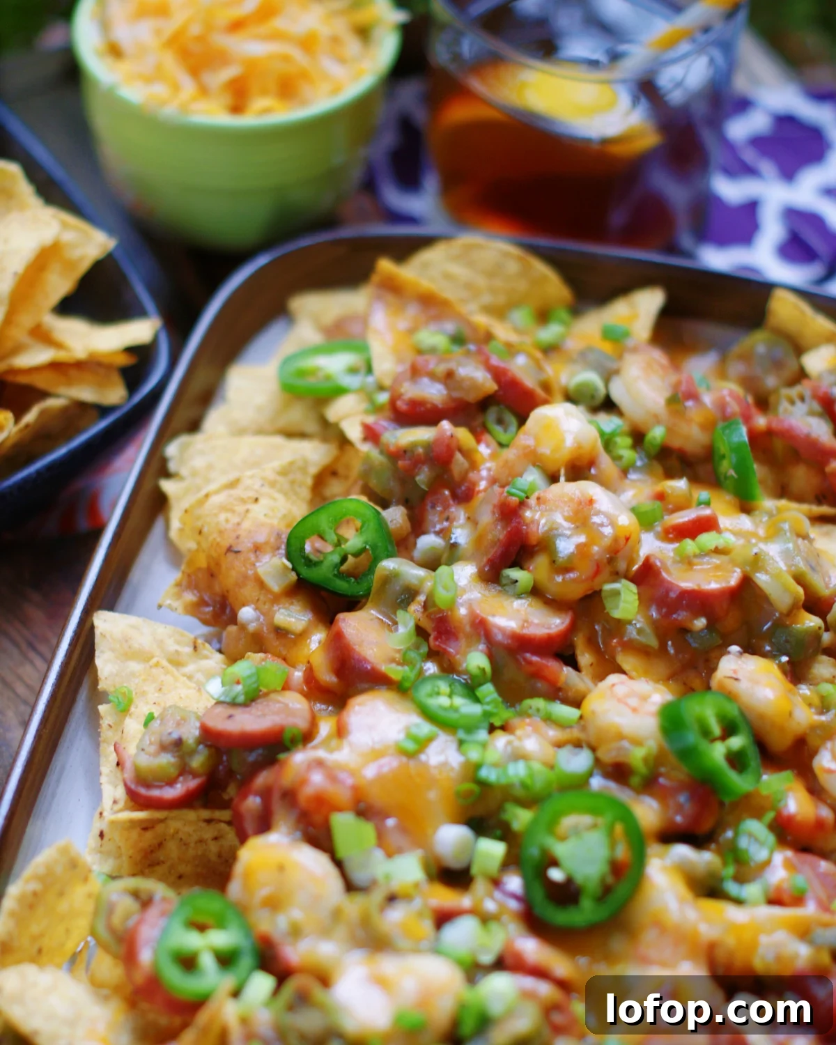 Sausage & Shrimp Gumbo spooned over nachos and topped with cheese and jalapenos.