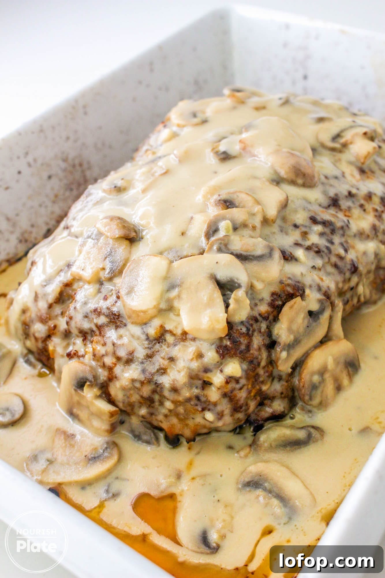 Savory Mushroom Meatloaf with Rich Mushroom Gravy 2 Mushroom meatloaf with gravy in a white baking dish