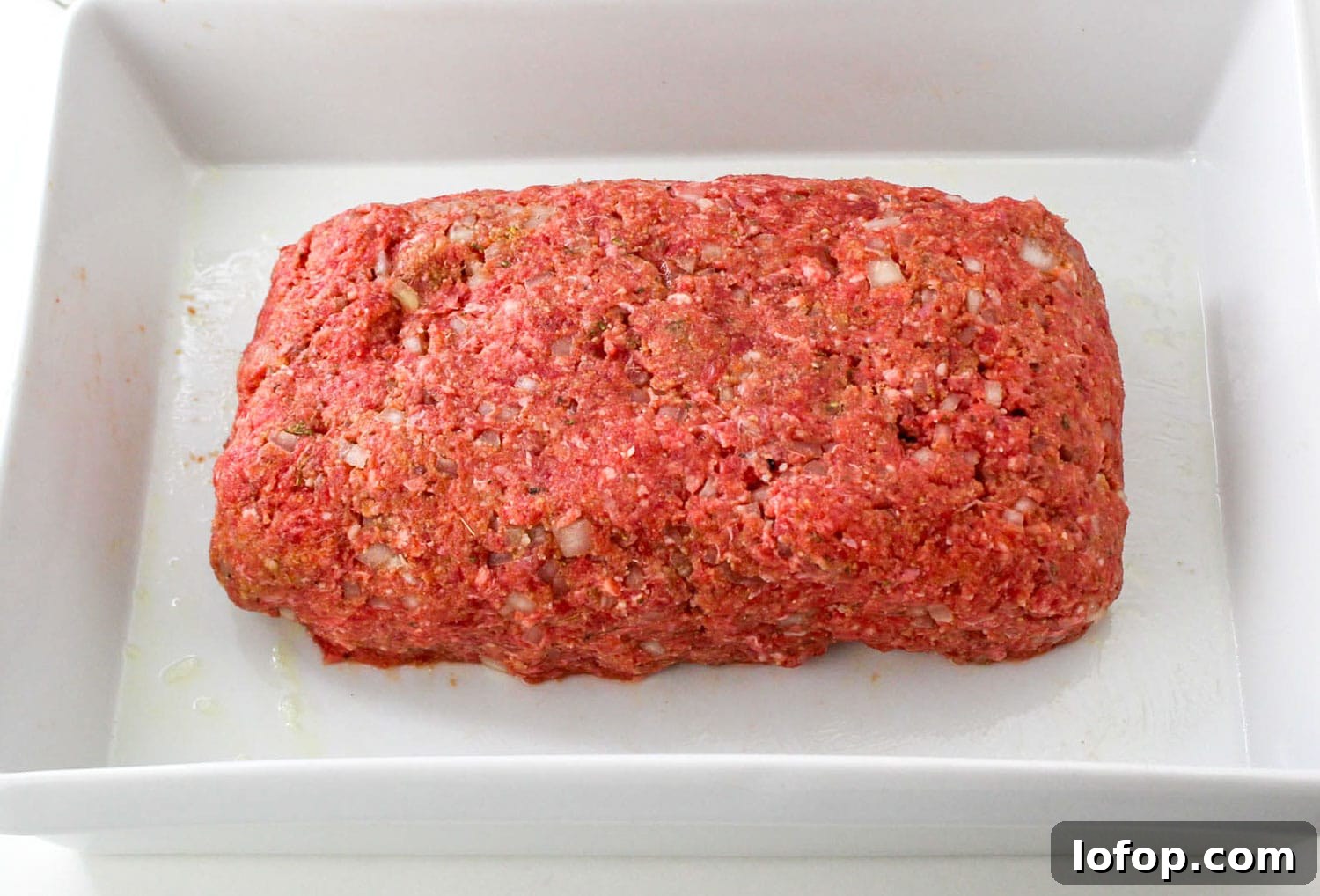 Savory Mushroom Meatloaf with Rich Mushroom Gravy 6 Raw meatloaf shaped and placed in a white baking pan