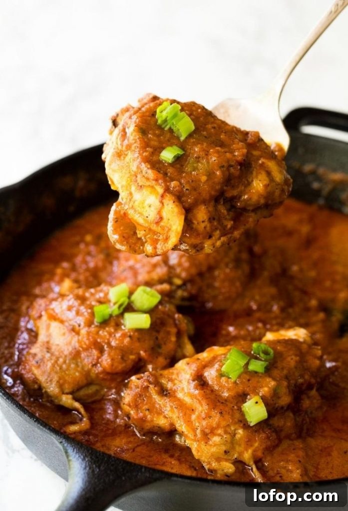 Pan-Seared Chicken Thighs in Creamy Tomato Sauce for Skillet Cooking 2 chicken in a pan surrounded and covered in a red sauce