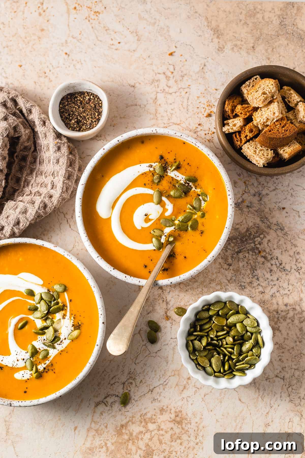 keto pumpkin soup bowls with croutons and pepitas