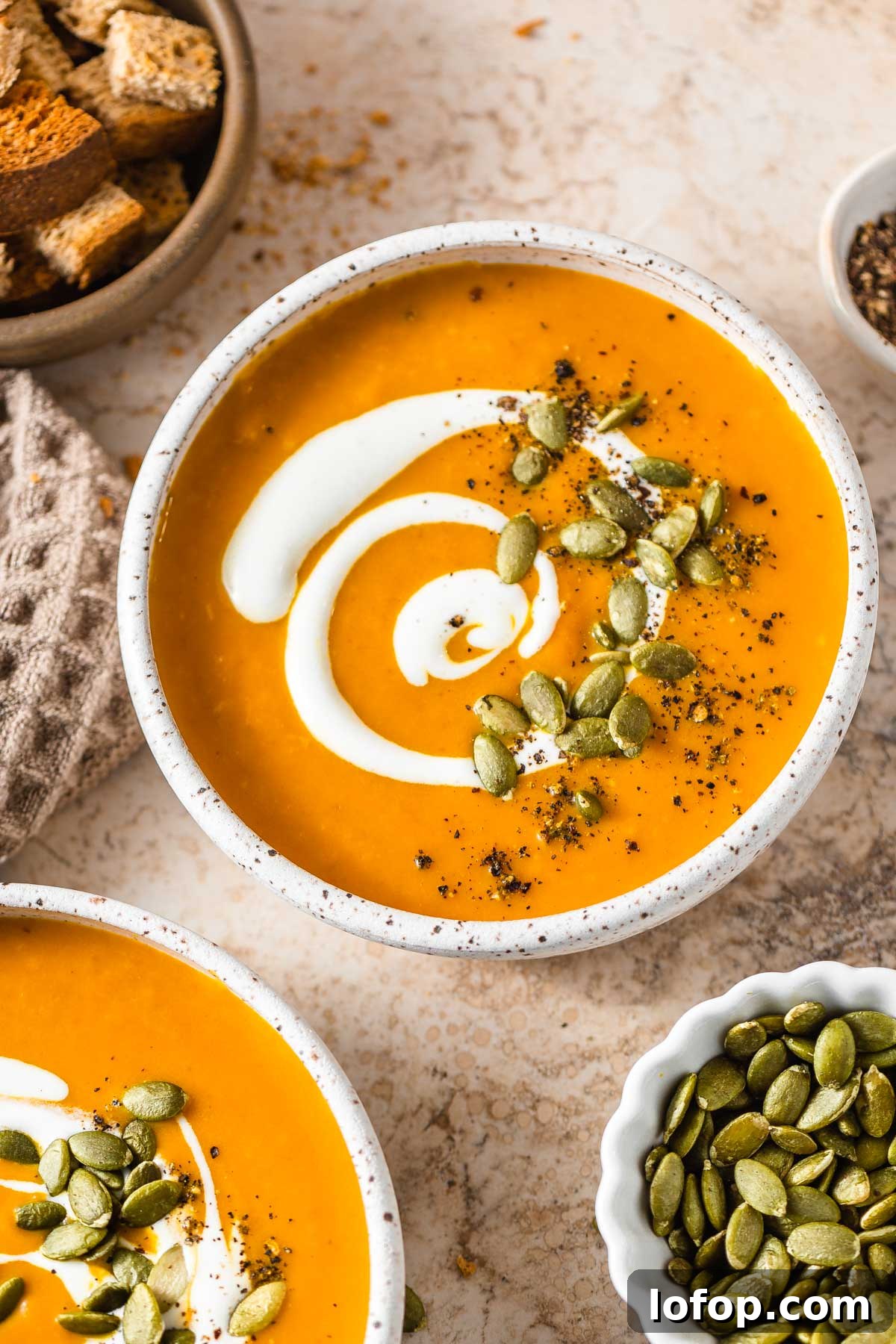 keto pumpkin soup with pepitas, croutons and cream
