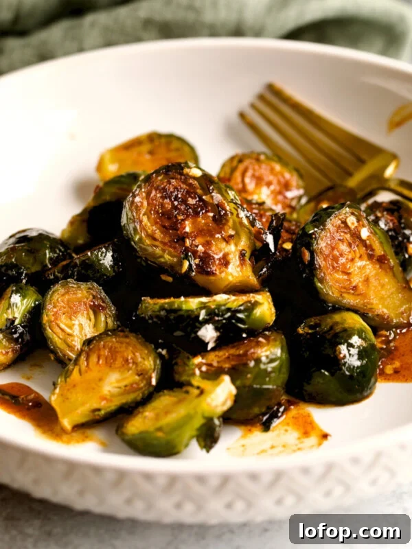 Copycat Chipotle Red Chili Salsa Recipe: Authentic Hot Salsa 15 Longhorn Steakhouse Crispy Brussels Sprouts on a plate.
