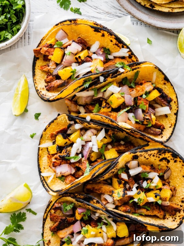 Copycat Chipotle Red Chili Salsa Recipe: Authentic Hot Salsa 16 Tacos al pastor on a platter.