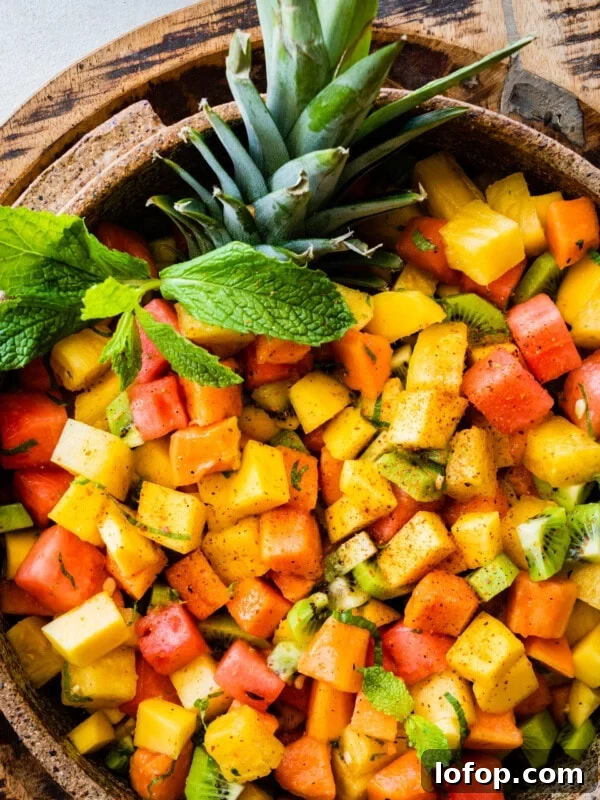 Copycat Chipotle Red Chili Salsa Recipe: Authentic Hot Salsa 17 Mexican Fruit Salad in a large bowl with mint.