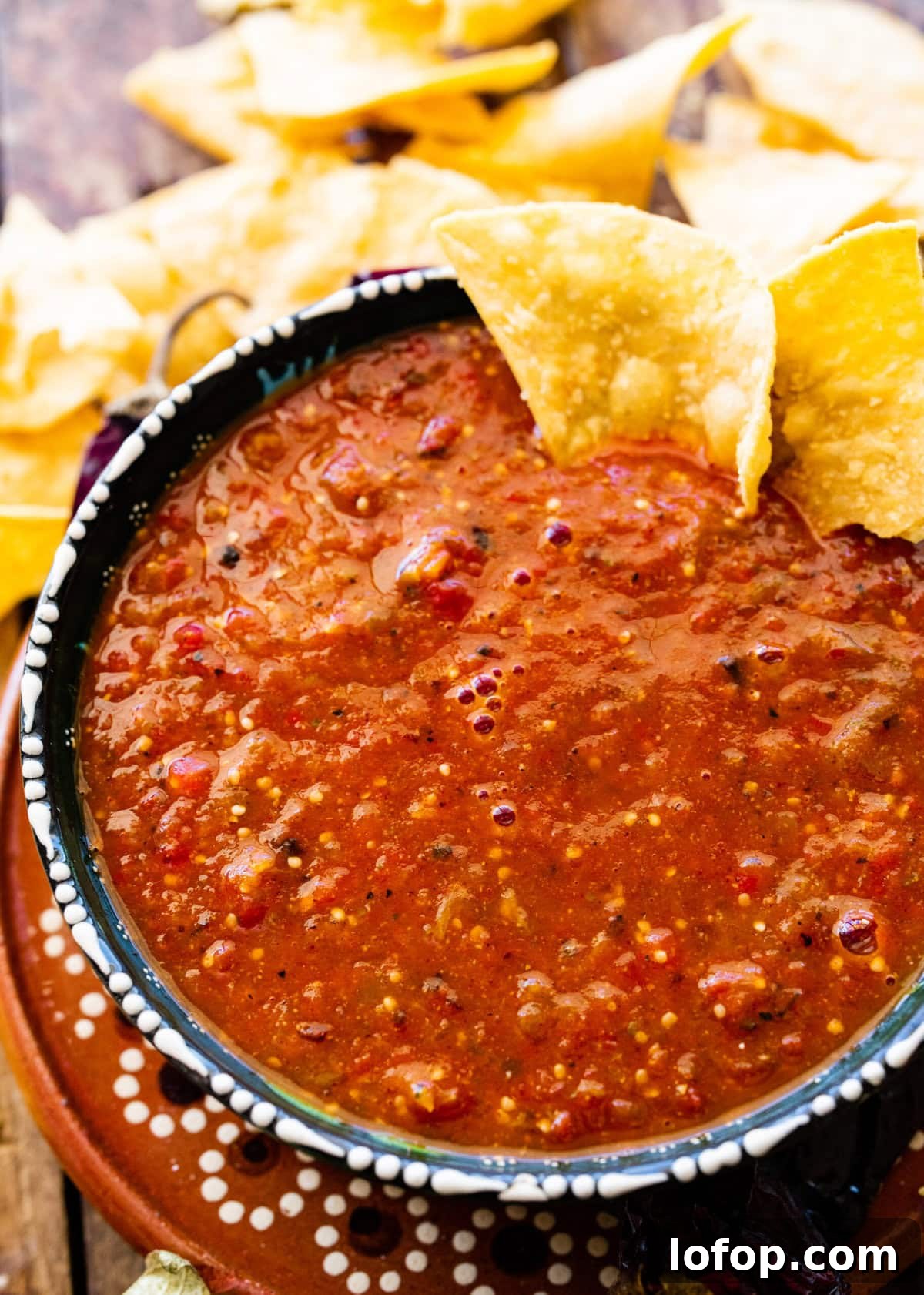 Copycat Chipotle Red Chili Salsa Recipe: Authentic Hot Salsa 3 Chipotle Hot Salsa Recipe (Copycat) in a Mexican-style bowl with limes and chips.