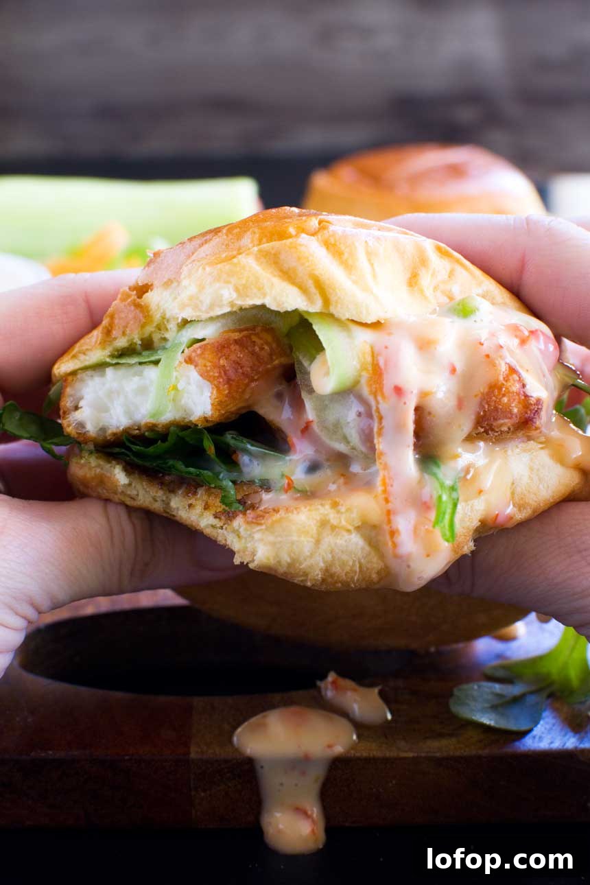 15-Minute Shanghai-Style Chicken Stir-Fry Recipe 7 Someone eating a crispy halloumi burger up close