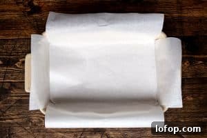 A rectangular baking dish lined with white parchment paper.