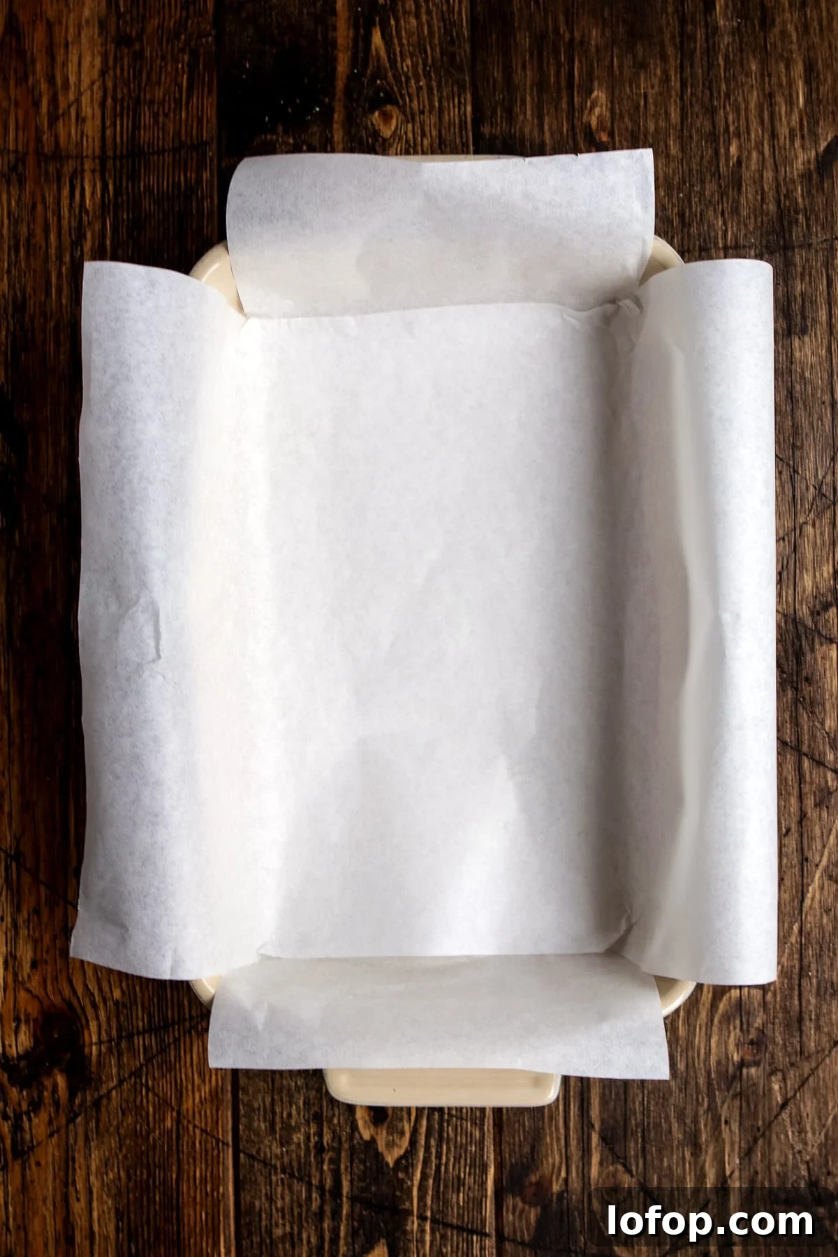 A rectangular baking dish lined with white parchment paper.