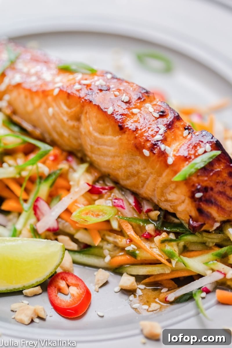 Asian glazed salmon on top of carrot and cucumber slaw with chillies.