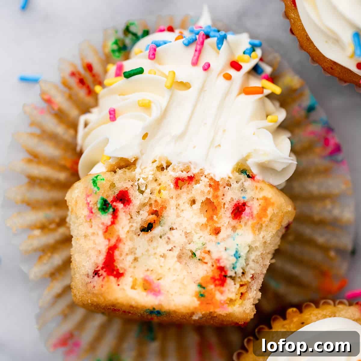 a Funfetti Cupcake with a bite taken out of it