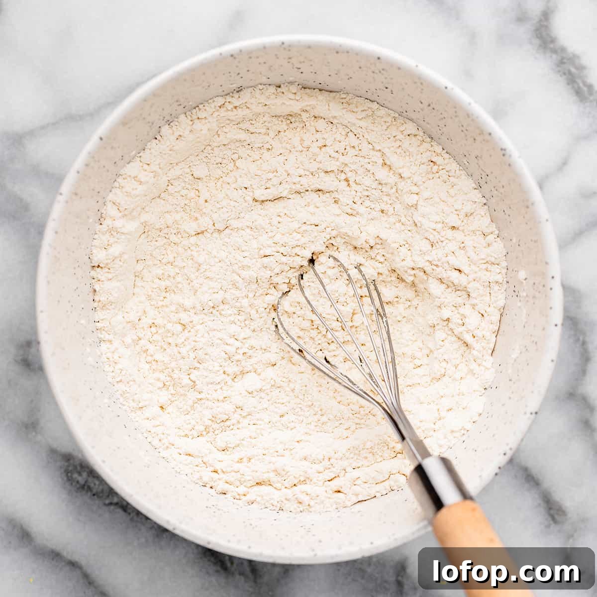 How to Make Funfetti Cupcakes from Scratch - whisking together dry ingredients.