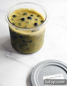 Vegan Blueberry Matcha Ice Cream Recipe (Ninja Creami, Dates & Oats) 9 Matcha blueberry vegan ice cream frozen in a Ninja Creami pint before spinning.