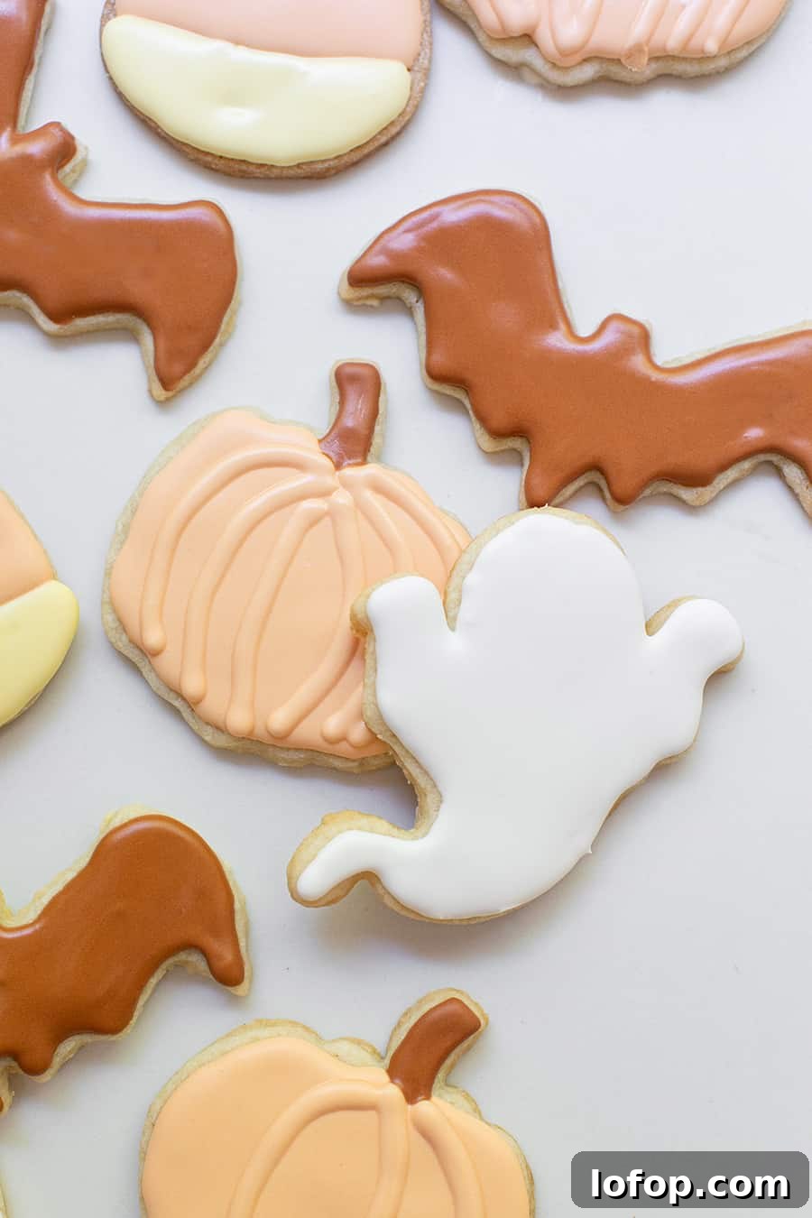 Spooky Halloween Sugar Cookie Recipe for Festive Treats 3 Halloween sugar cookies shaped as ghosts, pumpkins and bats.
