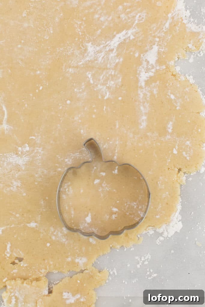Spooky Halloween Sugar Cookie Recipe for Festive Treats 5 A pumpkin cookie cutter on sugar cookie dough.