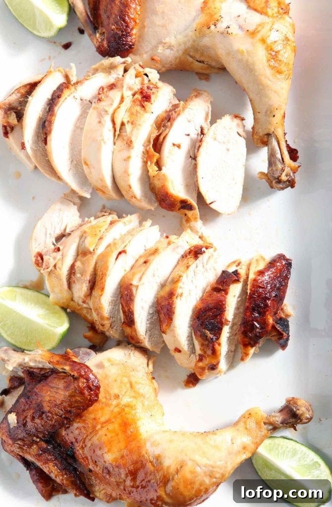 Spicy Chipotle-Lime Beer Can Chicken Recipe 2 beer can chicken sliced on a plate with a lime wedge