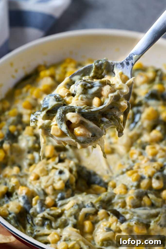 Scooping rajas con crema from a skillet.