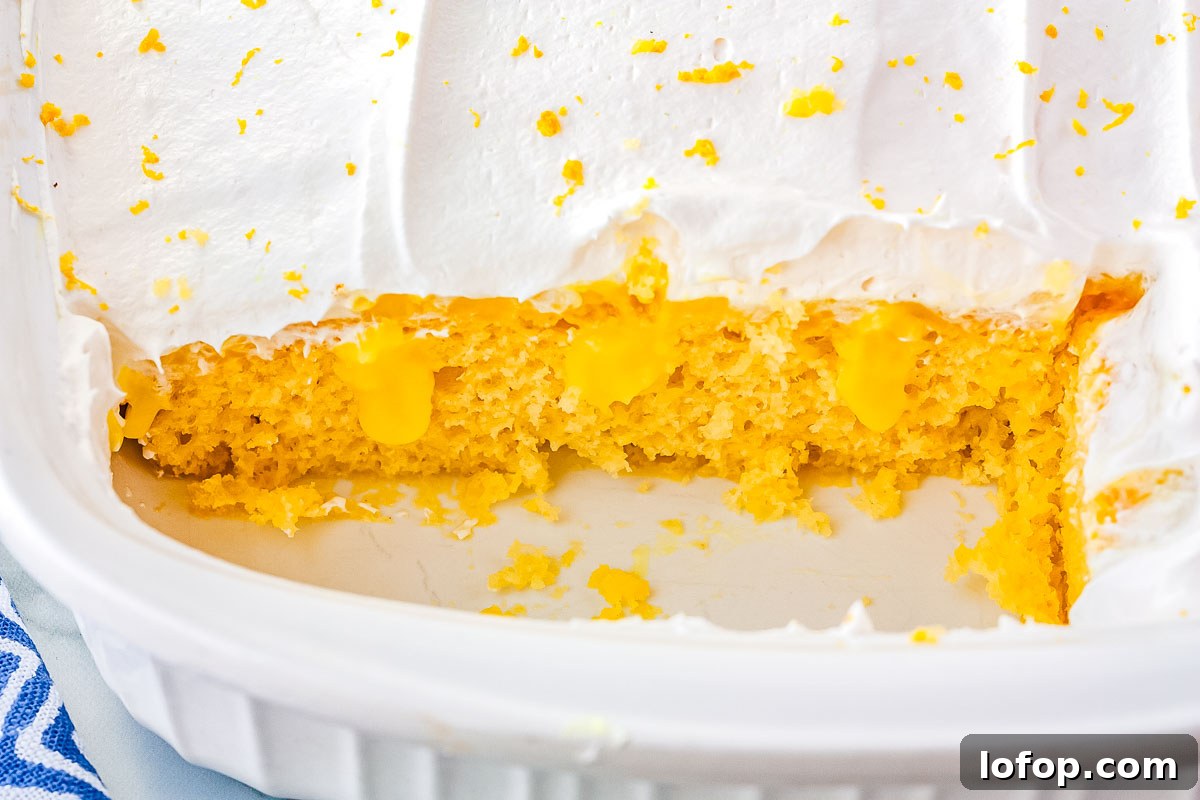 A close up interior shot of the finished lemon poke cake recipe.