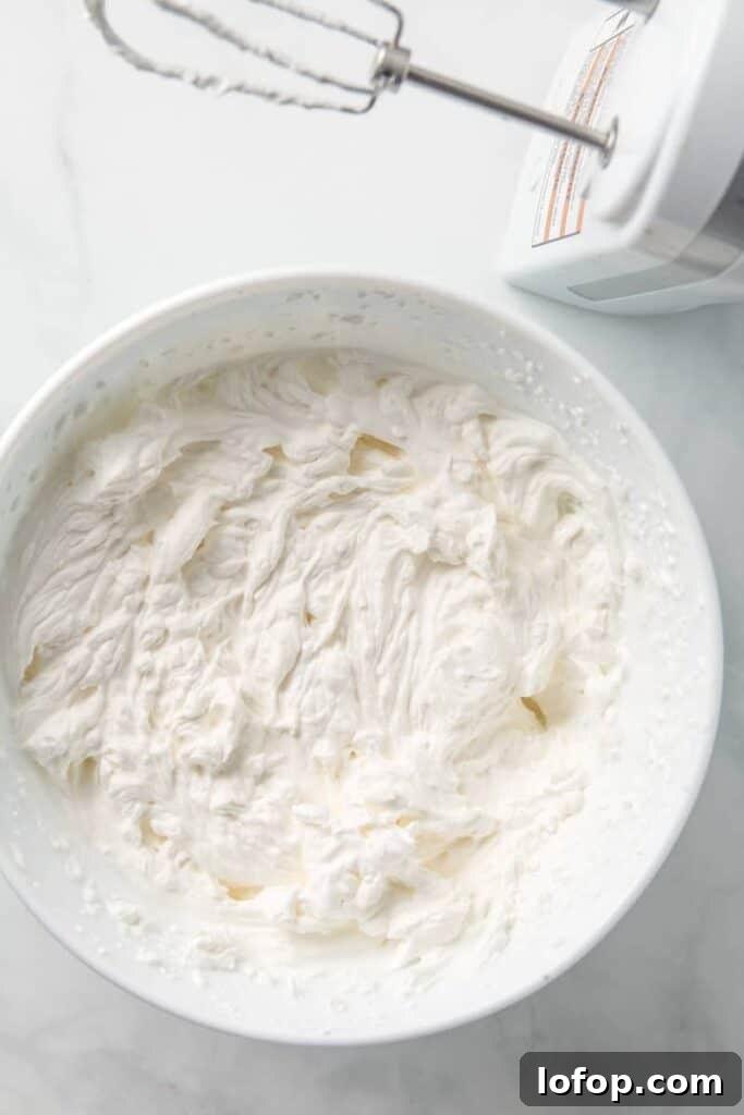 A bowl of heavy whipping cream, whipped to stiff peaks.