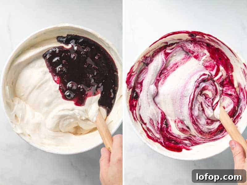 Blueberry sauce is folded into the ice cream base, leaving vibrant purple swirls in the bowl.