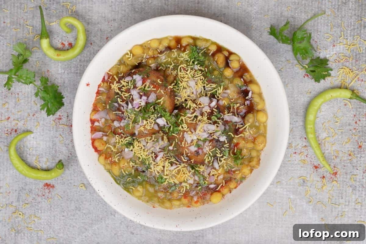 Ready ragda pattice topped with spices, onions and cilantro.