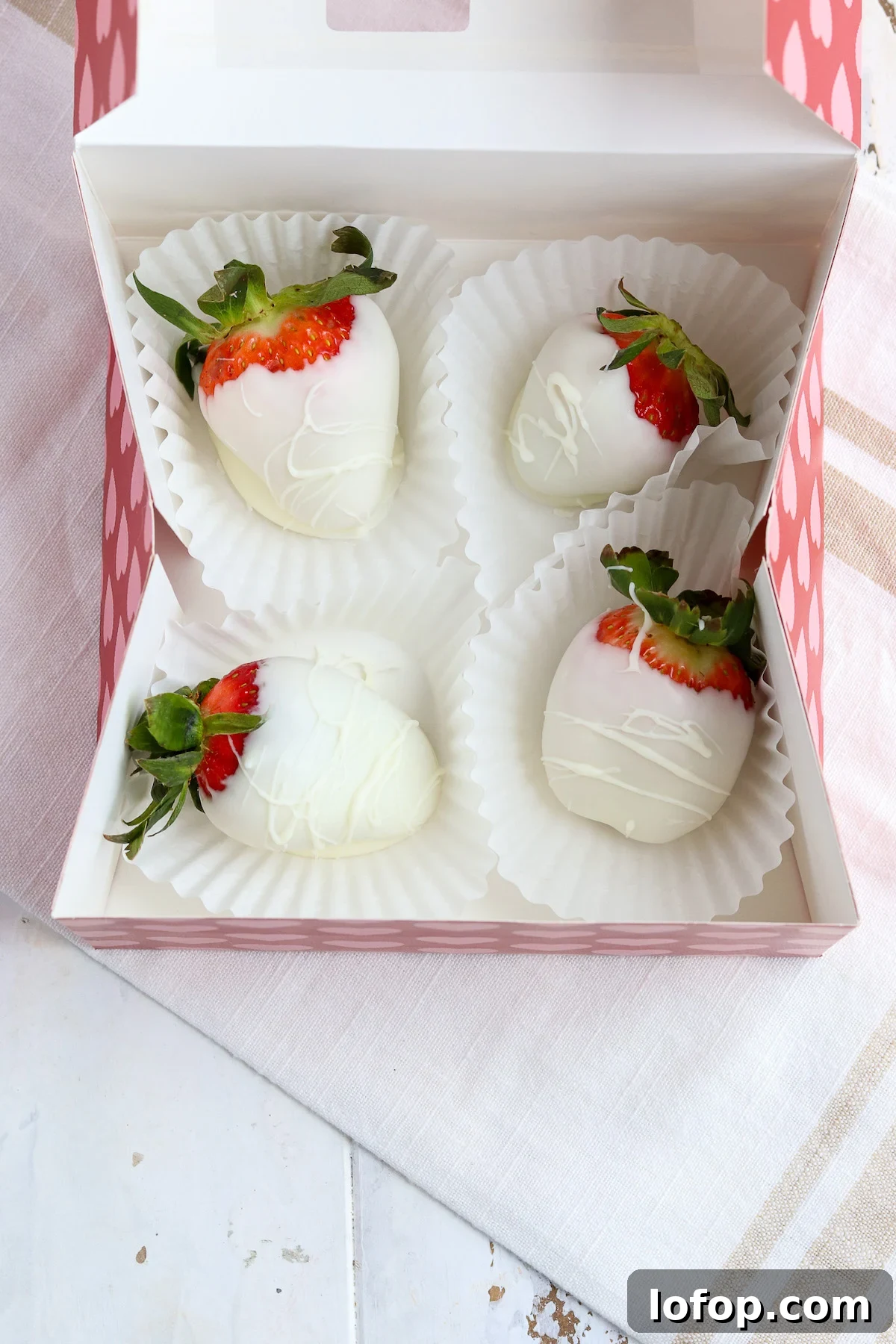 Storage tips for white chocolate covered strawberries in cupcake liners to prevent sweating.