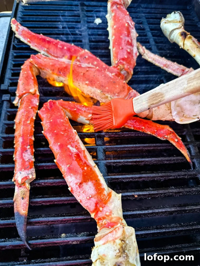 Garlic Butter Grilled King Crab Legs Recipe 2 king crab legs on a grill brushed with butter