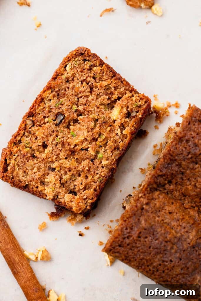 Ultra-Moist Gluten-Free Zucchini Bread with a Secret Ingredient 6 top down image of Extra Moist Gluten Free Zucchini Bread slice next to the loaf of bread