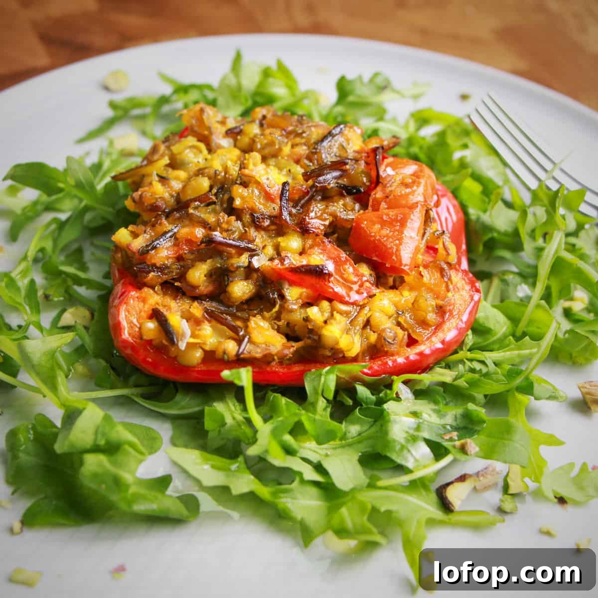 Perfect Instant Pot Mung Beans: Tender, Flavorful Every Time 13 Photo of a red pepper stuffed with spiced mung beans and wild rice, on a bed of rocket.