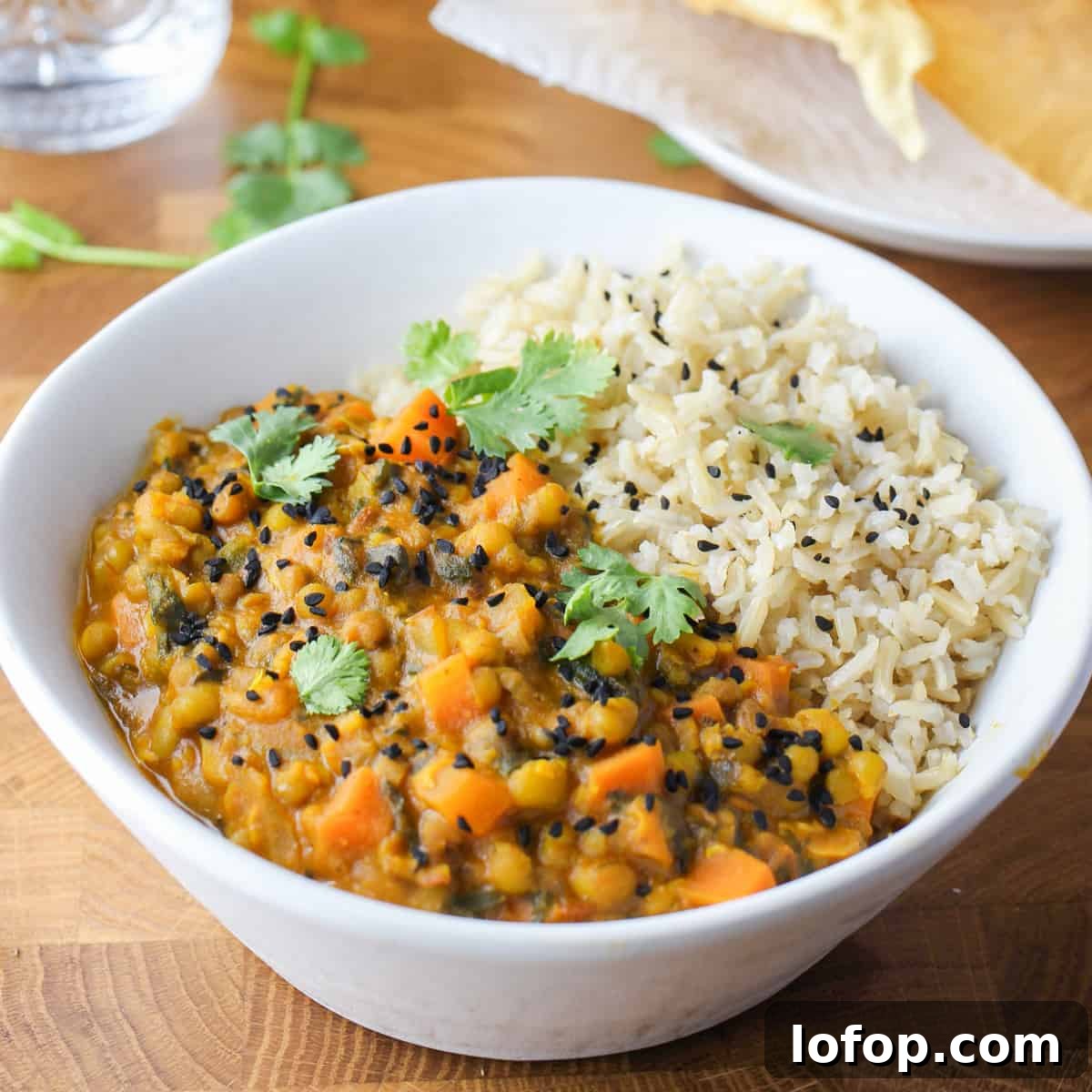 Perfect Instant Pot Mung Beans: Tender, Flavorful Every Time 14 Photo showing a white bowl with Mung Bean Curry and brown rice.