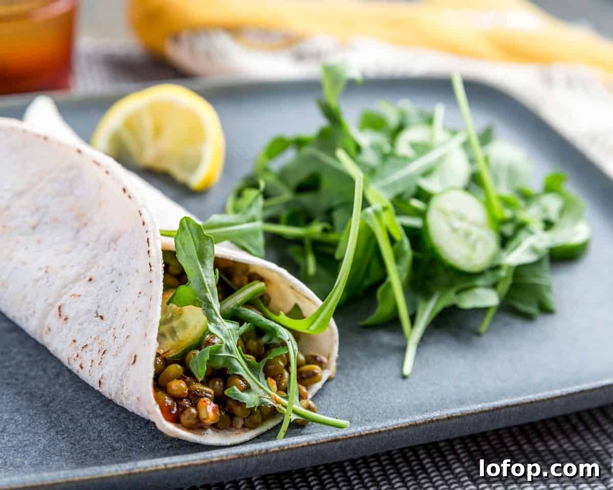 Perfect Instant Pot Mung Beans: Tender, Flavorful Every Time 16 Photo of a soft tortilla wrap filled with rocket, cucumber, mung beans and Sri racha sauce.