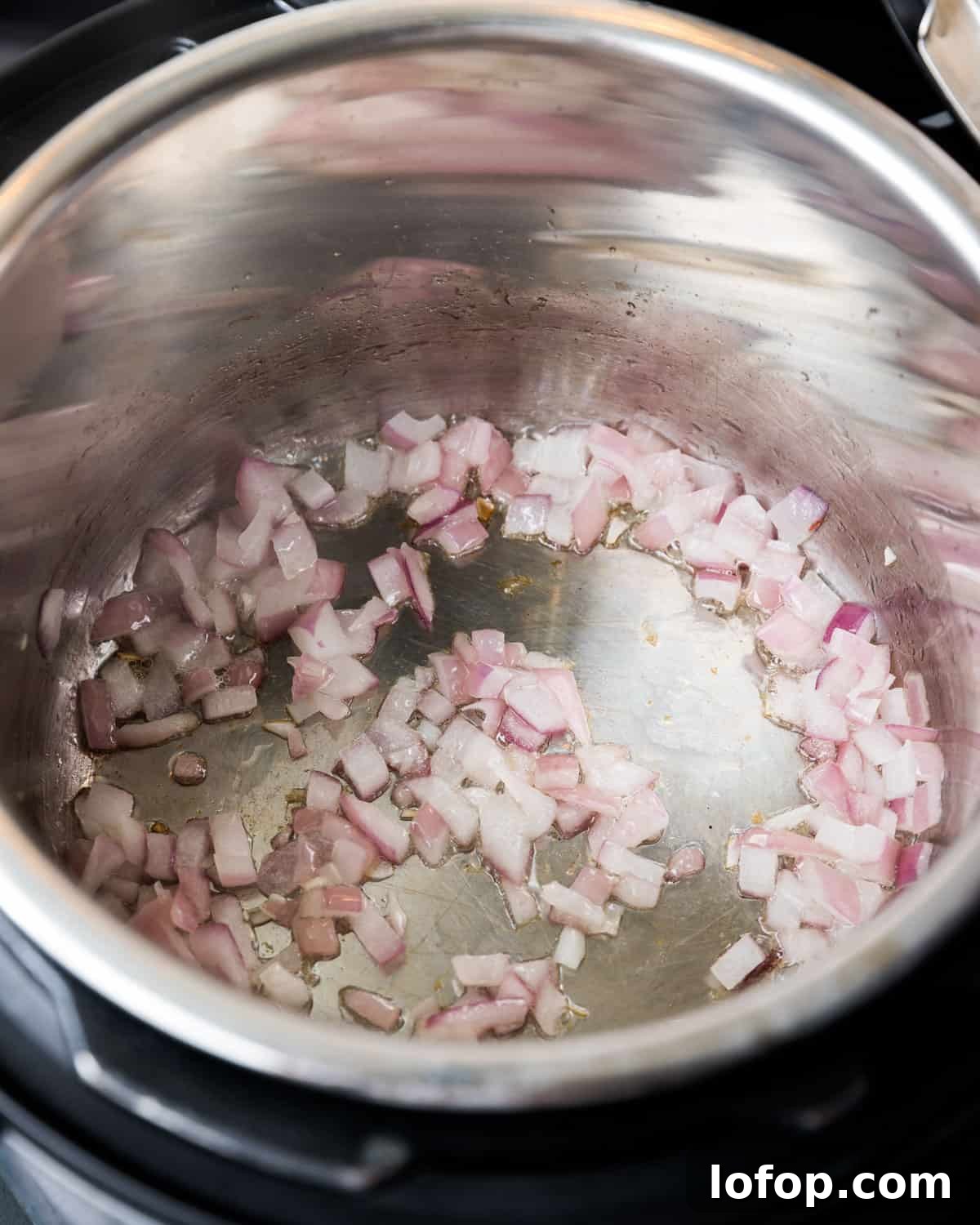 Perfect Instant Pot Mung Beans: Tender, Flavorful Every Time 17 Photo showing chopped onions being sautéed in the Instant Pot.